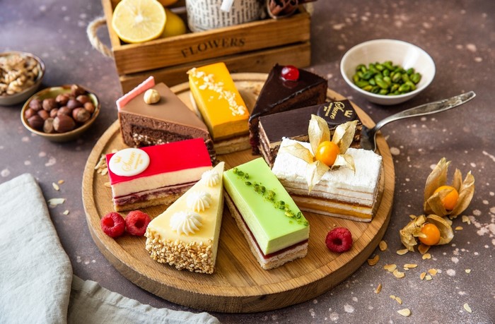 Assortment of cakes on a wooden board