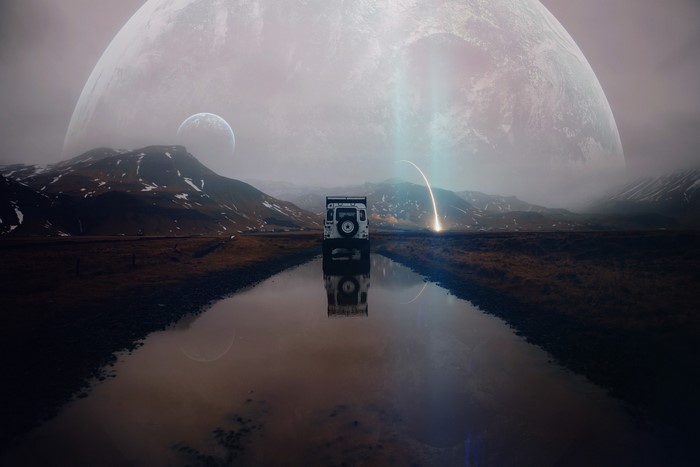 White SUV reflected in water with planets and mountains