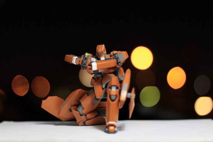 Orange robot toy with bokeh background