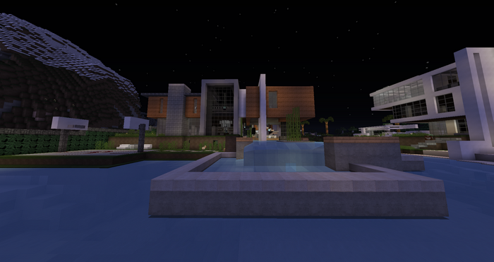 Modern Minecraft mansion with a pool at night