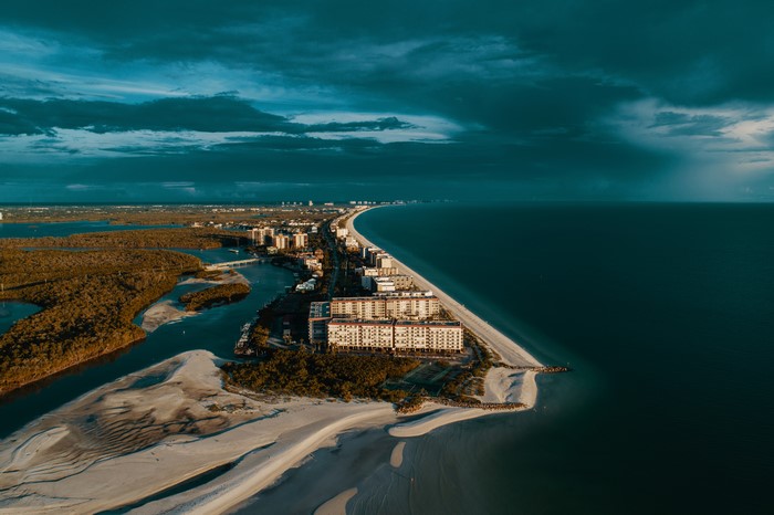 Aerial view of a coastal city with buildings and trees