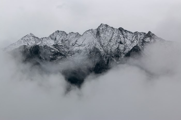 Snowy mountain peaks shrouded in mist