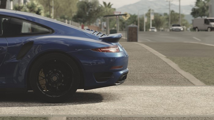 Blue Porsche 911 Turbo S on a Road