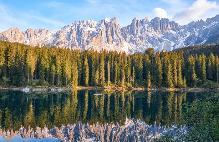 4K Karersee lake reflection of Dolomites mountains and forest