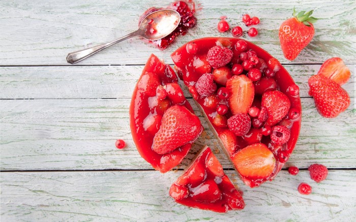 Berry cake with strawberries and raspberries on a wooden table