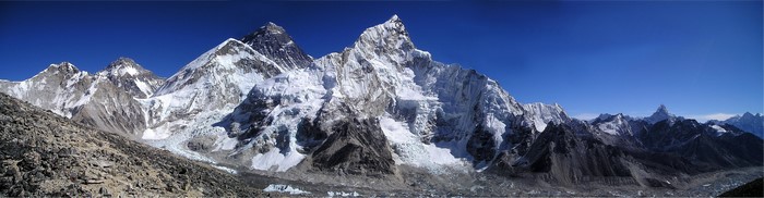 Panorama of snowy mountains under a blue sky
