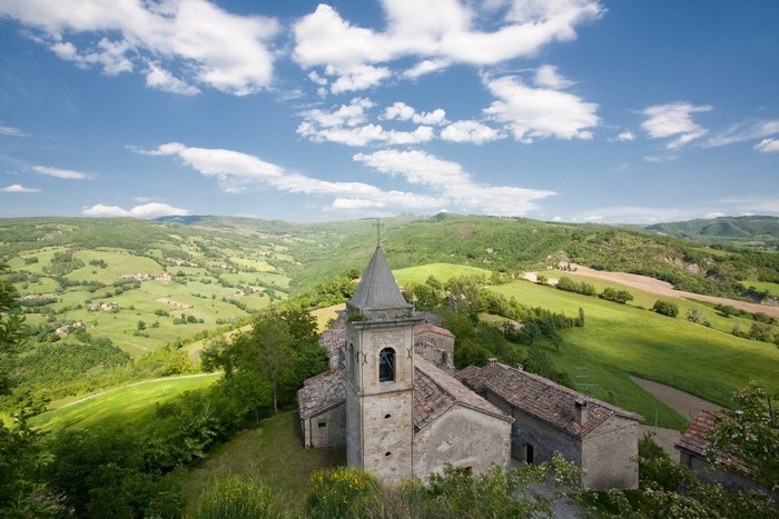 Church in a green hilly landscape in Italy