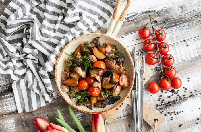 Roasted vegetables and tomatoes in a pan