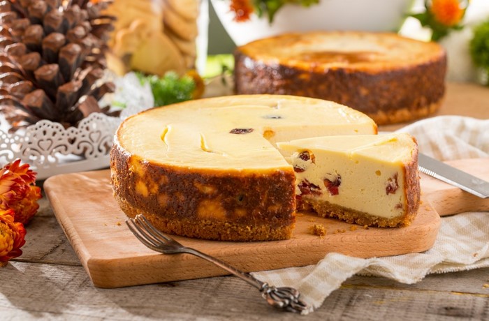 Cheesecake with berries on a wooden board