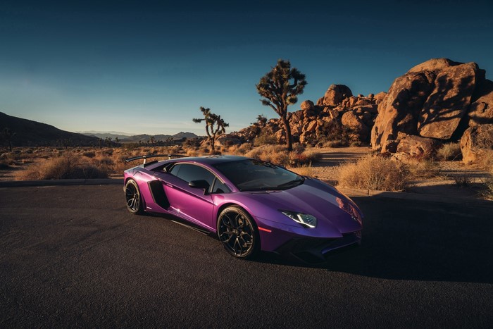 Purple Lamborghini Aventador in a desert landscape