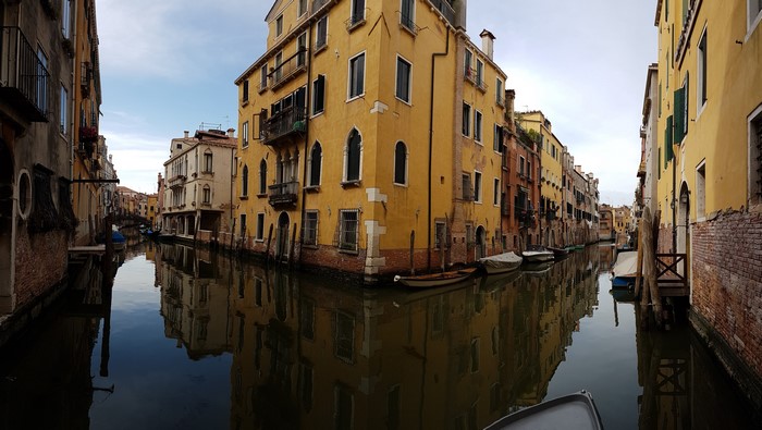 Venice canal with reflections in Italy