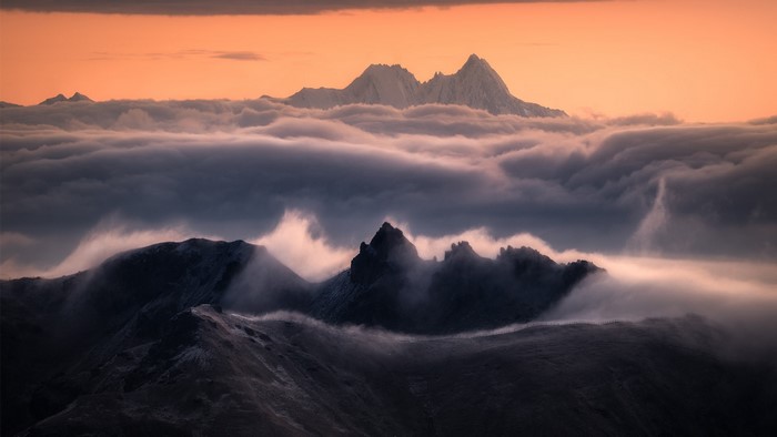 Mountains shrouded in mist at sunset