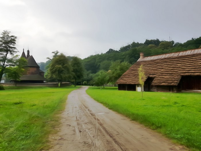Village with wooden church and house in Poland