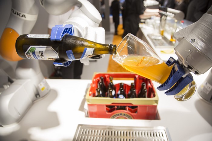 Robot pouring beer from bottle into glass