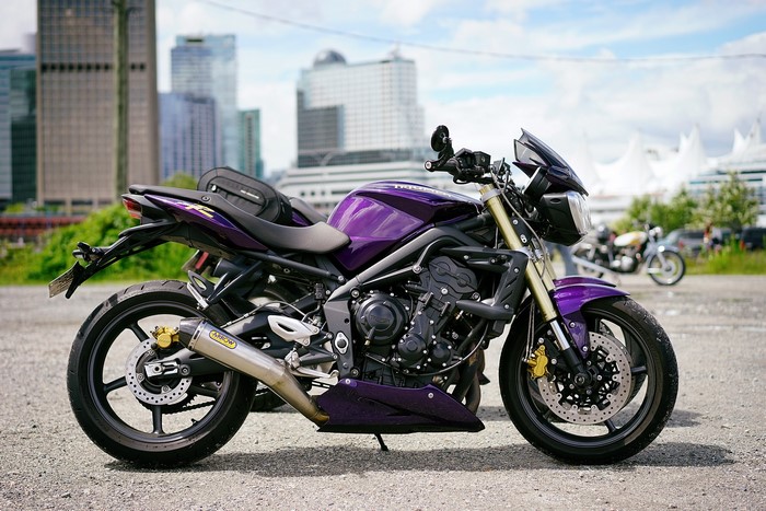 Purple Triumph Speed Triple motorcycle in city