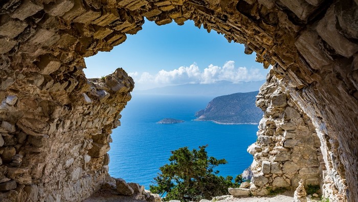 View of the sea and islands through a stone ruin
