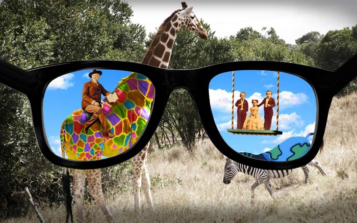 Glasses showing man on colorful giraffe and family on swing