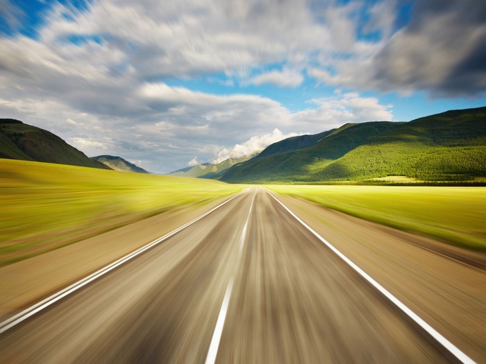 Road through mountains with motion blur