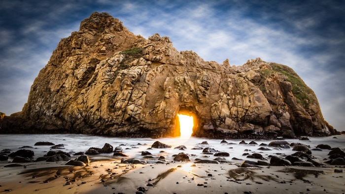 Archway in a rock formation on a beach