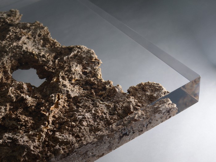 Rock formation encased in clear resin on a table