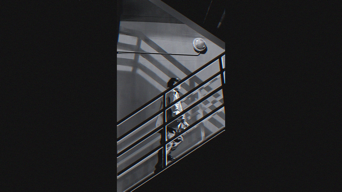 Man walking up stairs in monochrome