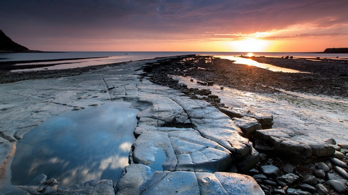 Rocky coastline at sunset with tide pools