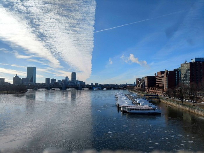 Boston cityscape with frozen Charles River and dramatic clouds