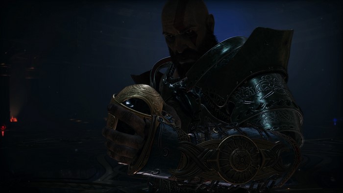Kratos from God of War holding a helmet