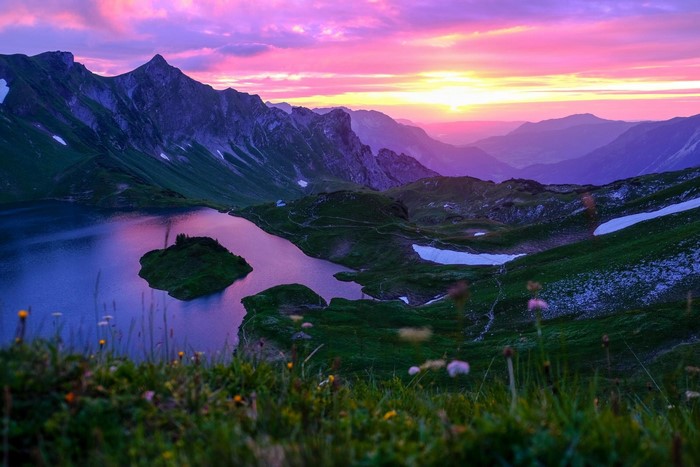 Mountain lake at sunset with purple and pink sky