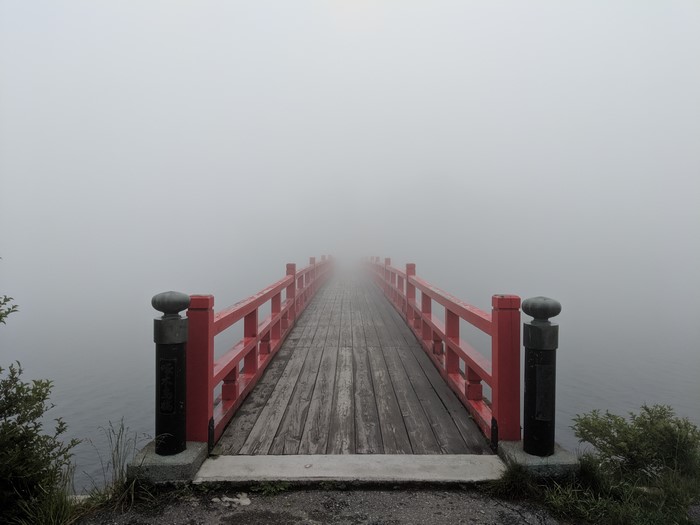 Red bridge in mist