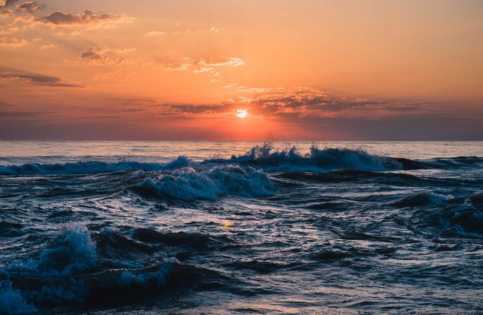 Sunset over the Black Sea with waves in Sochi, Russia