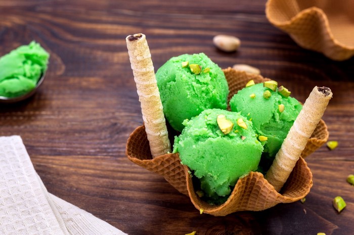 Pistachio ice cream in a waffle bowl with wafer sticks