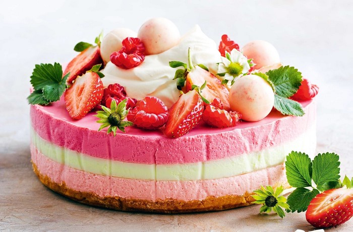 Layered berry mousse cake with fresh fruit