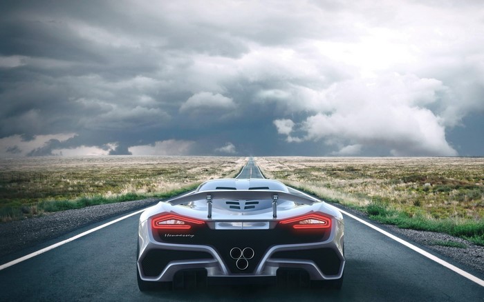 Hennessey Venom F5 driving on a road under stormy sky