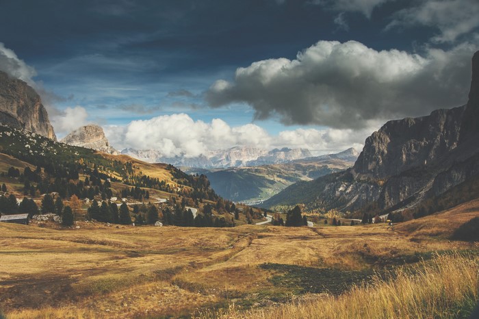 Mountain valley landscape with clouds and trees