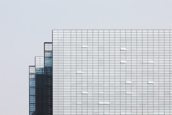 Modern glass skyscraper facade with stepped design