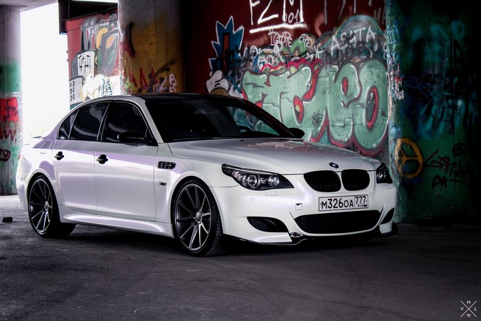 White BMW M5 E60 with graffiti background