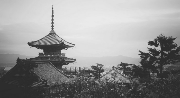 Monochrome view of a pagoda in Asia with distant mountains