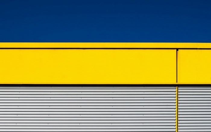 Abstract Yellow and Blue Building Facade with Corrugated Metal