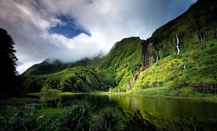Green mountains with waterfalls and a lake