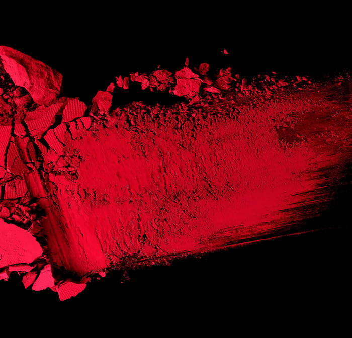 Abstract red powder smear on black background