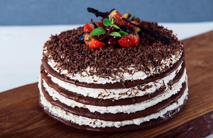 Chocolate layer cake with whipped cream and berries