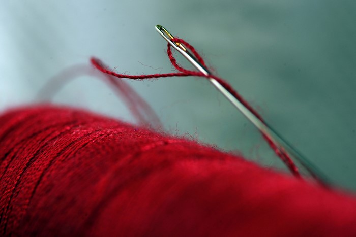 Close-up of red thread and needle