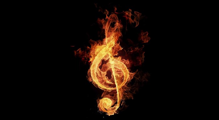 Treble clef made of fire on a black background
