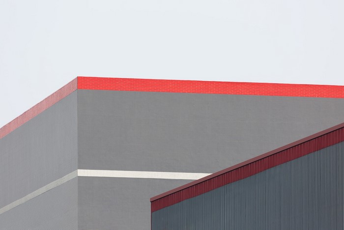 Abstract geometric building facade with red trim