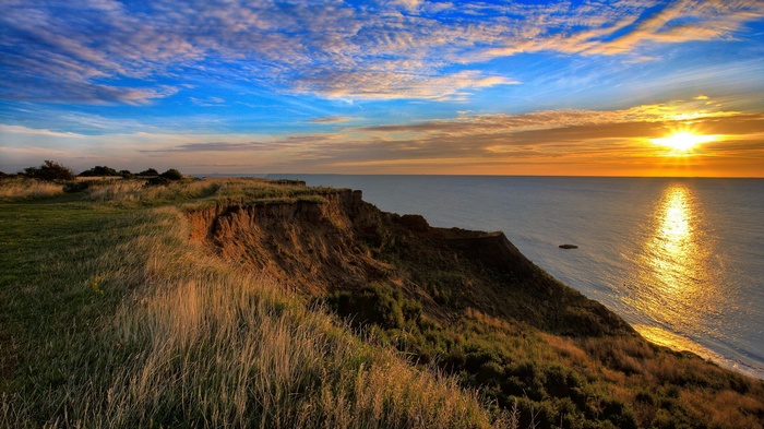 Cliff overlooking the ocean at sunset