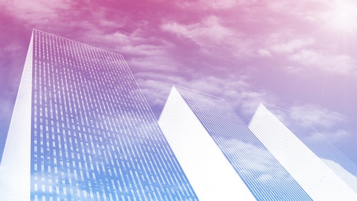 Skyscrapers against a pink and blue sky with clouds