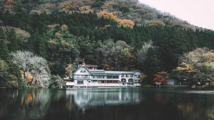 House on the lake with forest and mountains