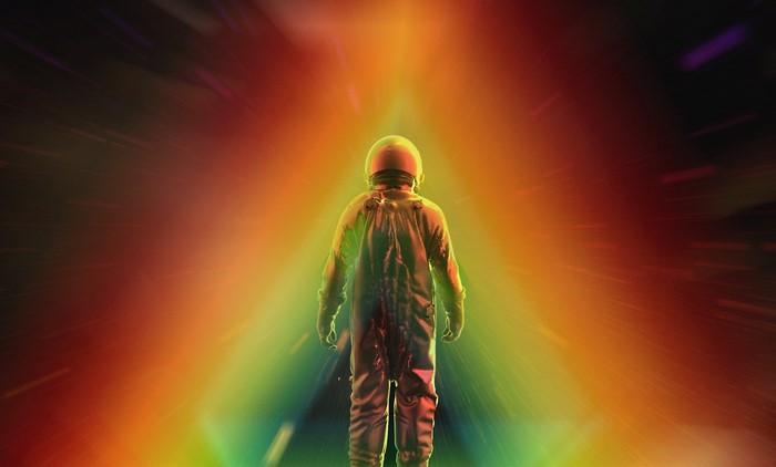 Astronaut walking through colorful light