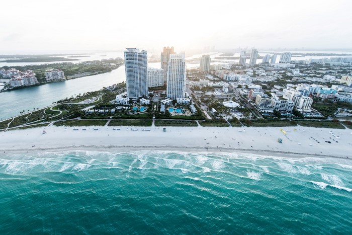 Miami Beach cityscape with skyscrapers and ocean waves